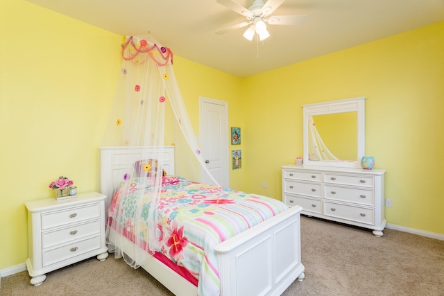 bedroom with a ceiling fan, light carpet, and baseboards