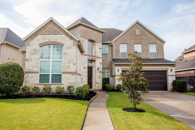 view of front facade with stone siding, a front yard, concrete driveway, and brick siding