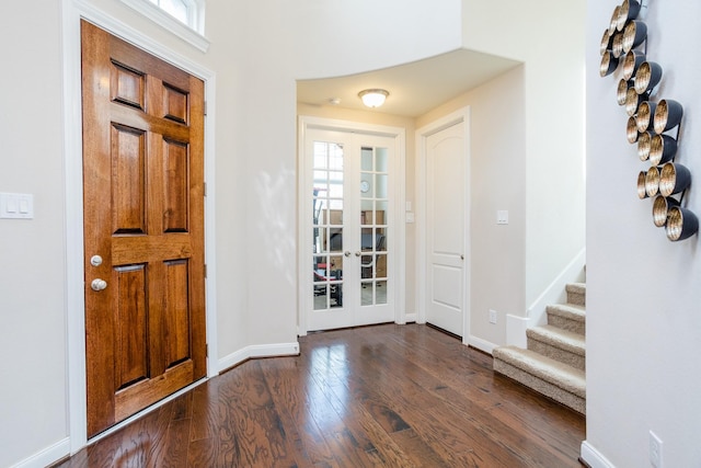 foyer with french doors, stairway, hardwood / wood-style flooring, and baseboards