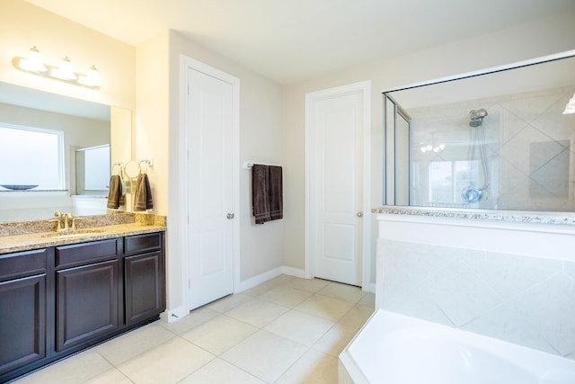 bathroom featuring baseboards, tile patterned flooring, vanity, a shower stall, and a bath