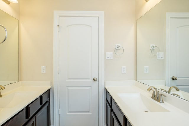 bathroom with two vanities and a sink