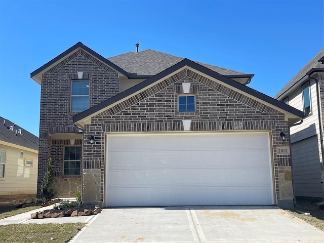 view of front facade featuring a garage, driveway, brick siding, and a shingled roof