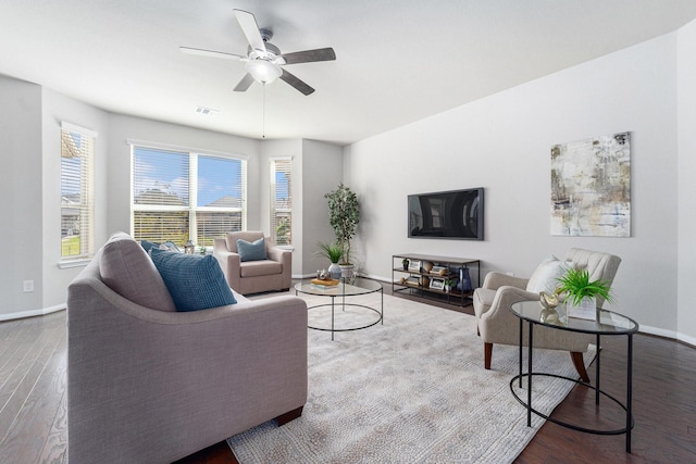 living room with visible vents, wood finished floors, a ceiling fan, and baseboards