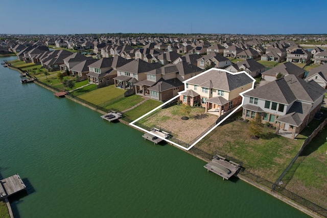 bird's eye view featuring a residential view and a water view