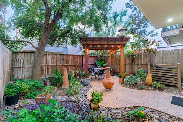 view of patio / terrace featuring outdoor dining space, a fenced backyard, and a pergola