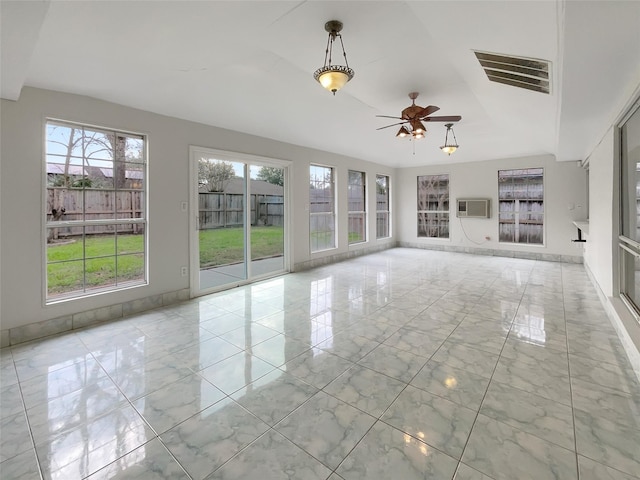 unfurnished living room with baseboards, visible vents, a ceiling fan, a wall unit AC, and marble finish floor