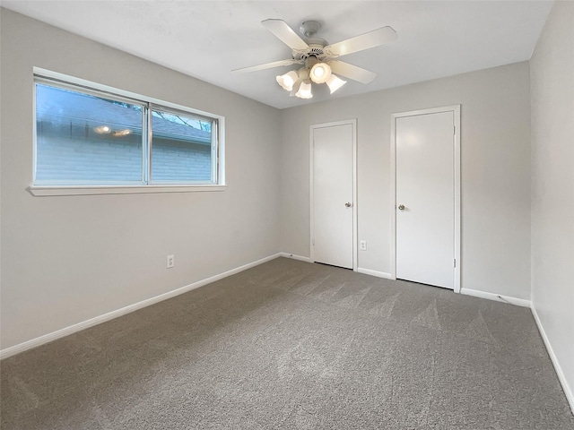 unfurnished bedroom featuring ceiling fan, baseboards, and carpet flooring