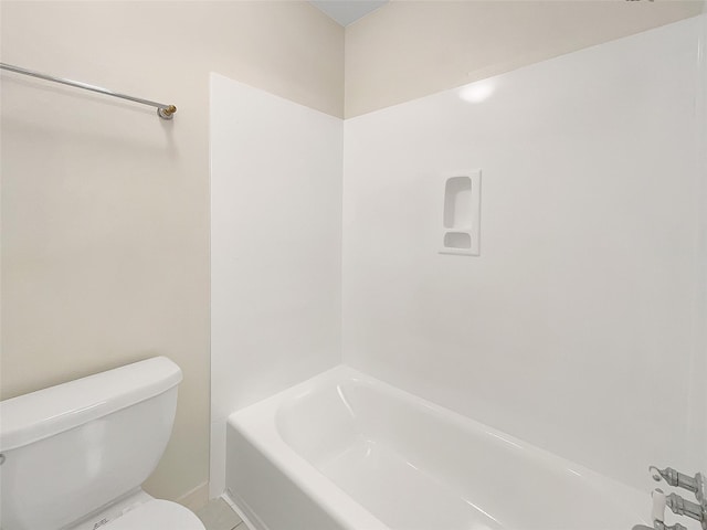 bathroom featuring a tub, a shower, and toilet