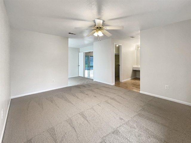 spare room with a ceiling fan, baseboards, visible vents, and carpet flooring