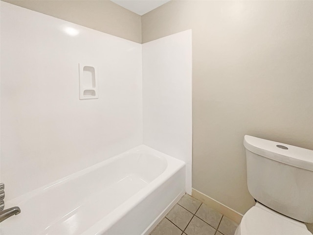 full bath with toilet, tile patterned flooring, baseboards, and a bath