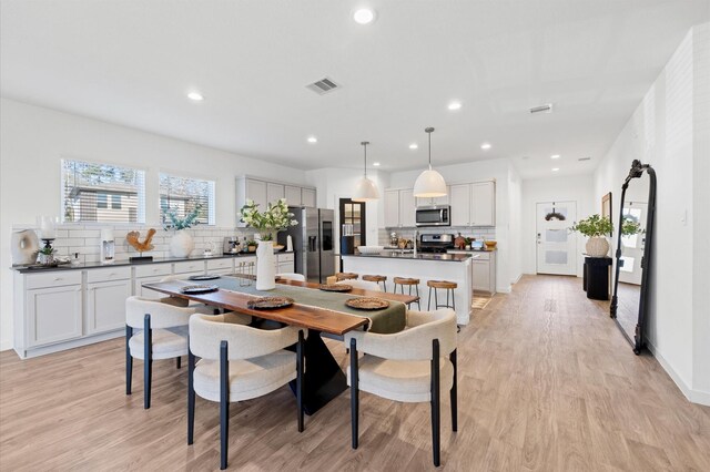 dining space featuring recessed lighting, visible vents, and light wood-style flooring