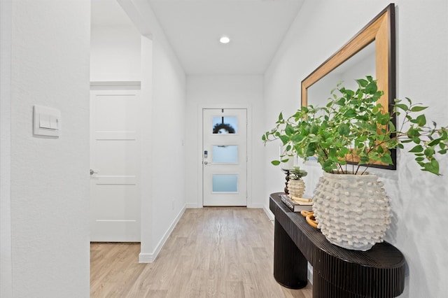 entryway featuring recessed lighting, wood finished floors, and baseboards