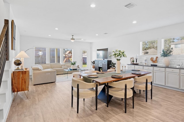 dining room featuring light wood-style flooring, recessed lighting, visible vents, and a wealth of natural light