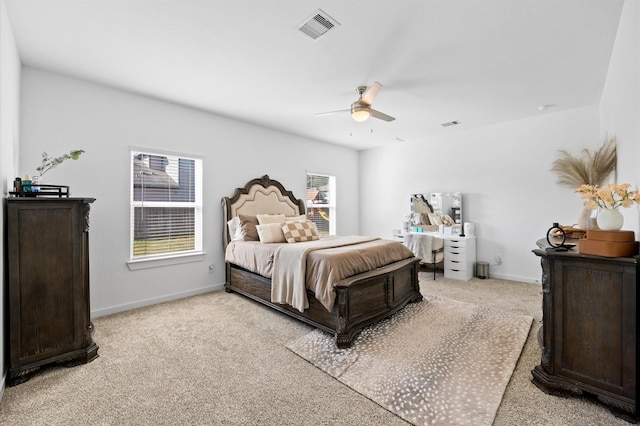 bedroom with a ceiling fan, baseboards, visible vents, and light carpet