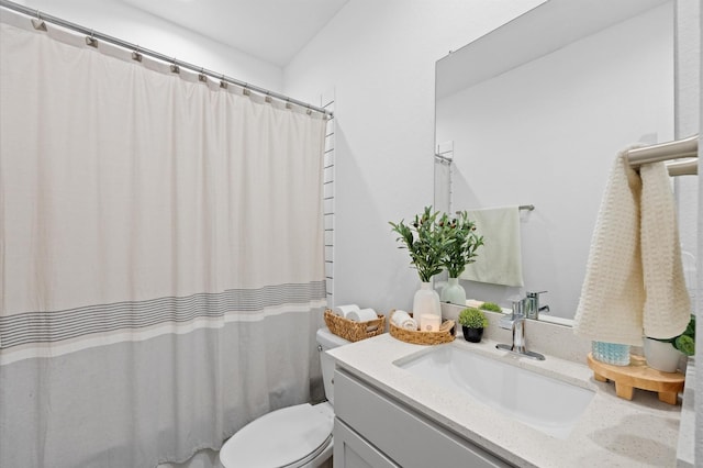 bathroom featuring a shower with curtain, toilet, and vanity