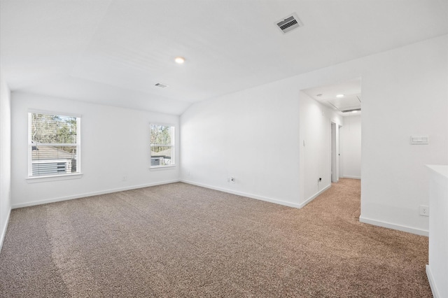 unfurnished room with baseboards, visible vents, and light carpet