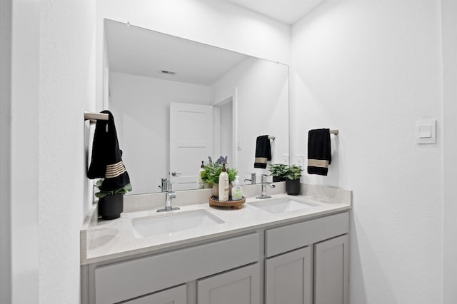 bathroom with double vanity and a sink