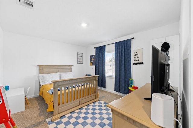 carpeted bedroom with visible vents and baseboards