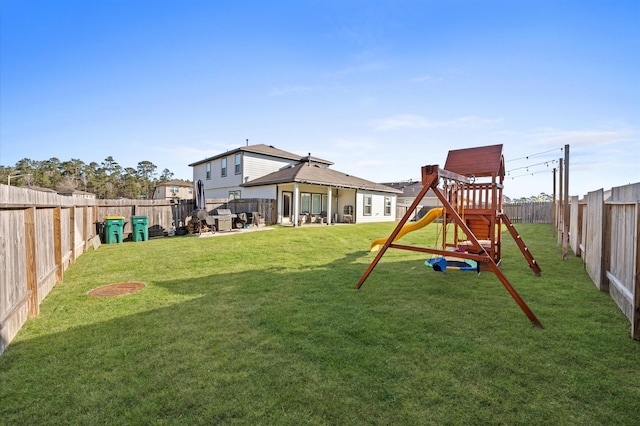 exterior space with a patio area, a playground, and a fenced backyard