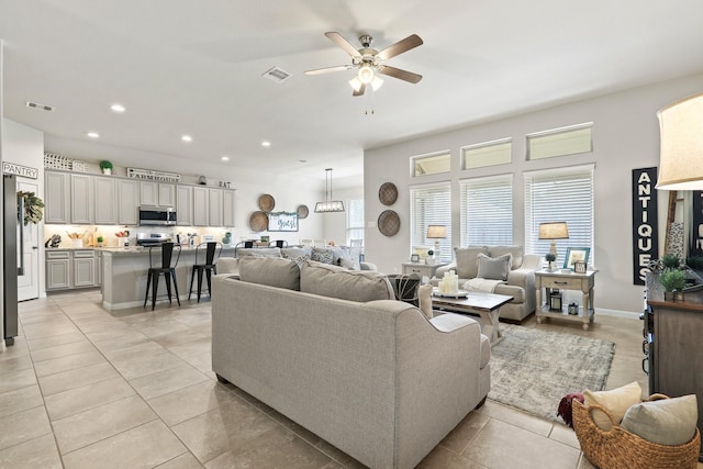 living area with light tile patterned floors, recessed lighting, visible vents, and ceiling fan