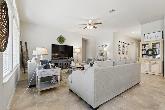 living area with visible vents and a ceiling fan