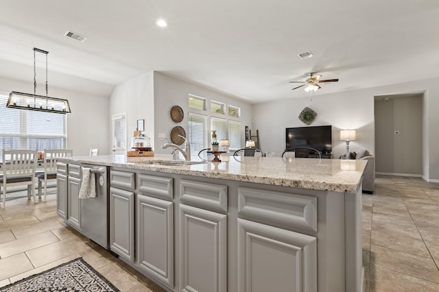 kitchen with visible vents, dishwasher, ceiling fan with notable chandelier, gray cabinets, and a sink