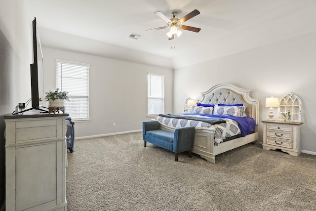 carpeted bedroom with visible vents, baseboards, and ceiling fan