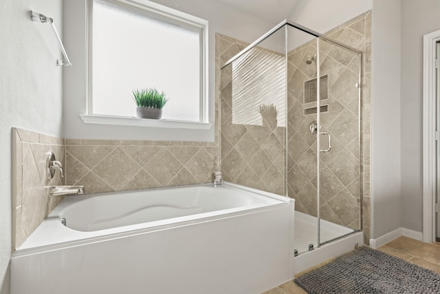 full bathroom with tile patterned floors, a garden tub, and a shower stall