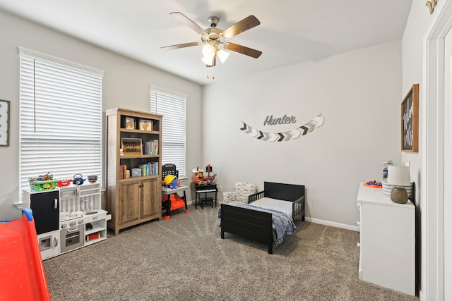 sitting room with baseboards, carpet, and a ceiling fan