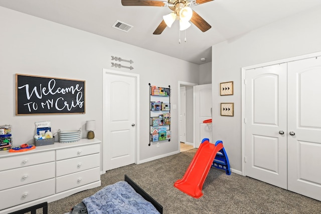 carpeted bedroom with a ceiling fan, baseboards, visible vents, and a closet