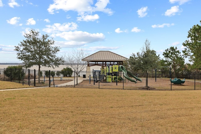 community play area with fence and a lawn