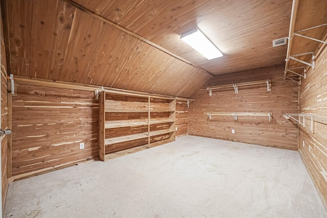 interior space featuring lofted ceiling, visible vents, and carpet flooring