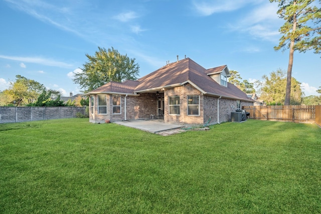 rear view of property with a fenced backyard, a yard, a patio area, central AC, and brick siding