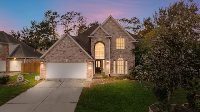 view of front of property with a garage, concrete driveway, brick siding, and a lawn