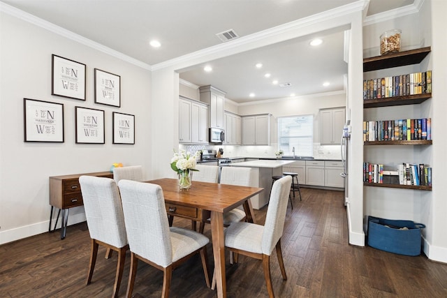 dining room with baseboards, visible vents, dark wood-style flooring, and ornamental molding