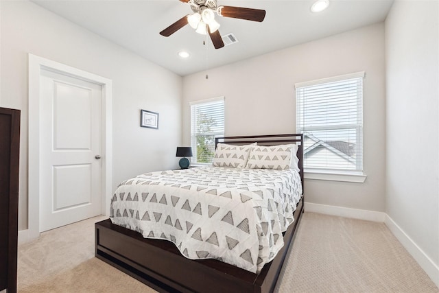 bedroom featuring recessed lighting, light colored carpet, a ceiling fan, baseboards, and visible vents