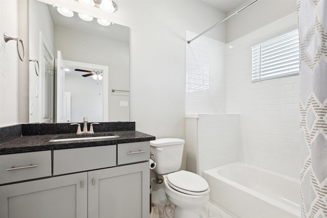 bathroom featuring ceiling fan, washtub / shower combination, vanity, and toilet