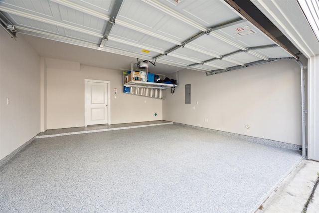 garage with a garage door opener, electric panel, and baseboards