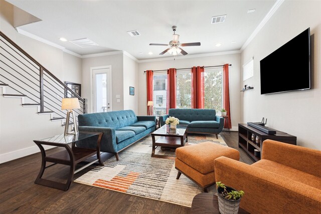 living area featuring crown molding, dark wood-style flooring, visible vents, and baseboards