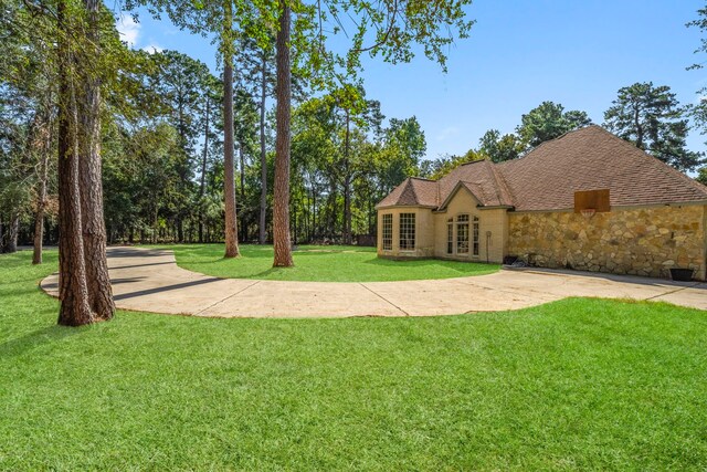 view of front facade featuring stone siding, french doors, and a front lawn