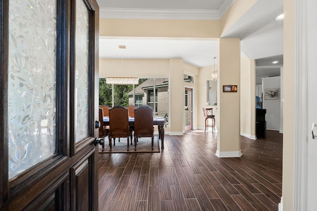 entryway with baseboards, crown molding, a chandelier, and wood tiled floor