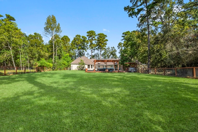 view of yard with fence and a pergola