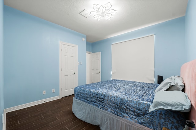 bedroom featuring wood finish floors and baseboards