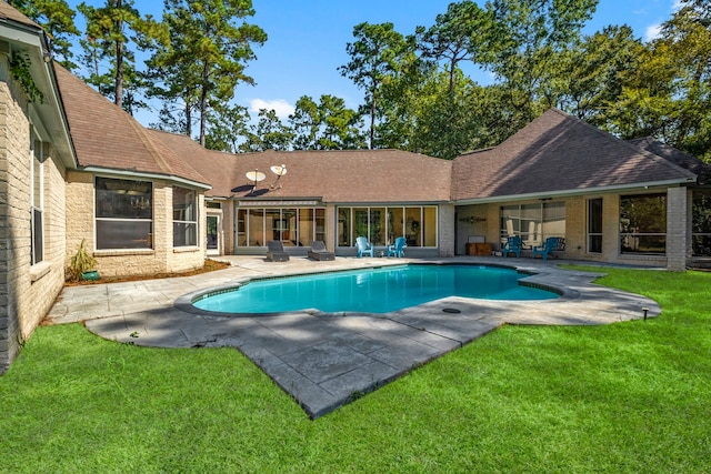 pool featuring a lawn and a patio