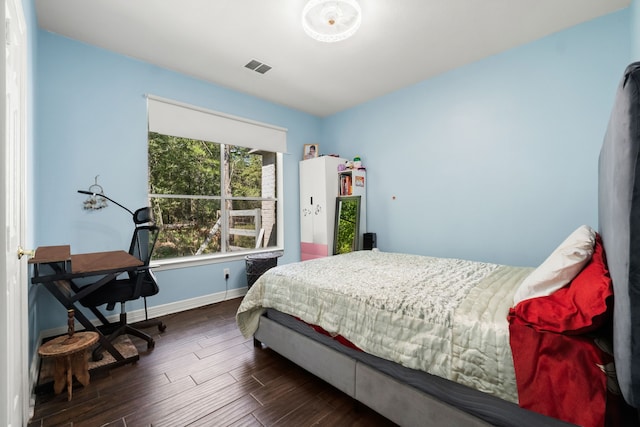 bedroom featuring dark wood-type flooring, visible vents, and baseboards