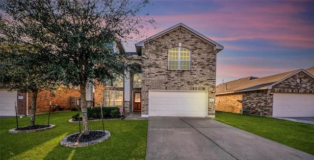 traditional-style home featuring driveway, brick siding, a lawn, and an attached garage