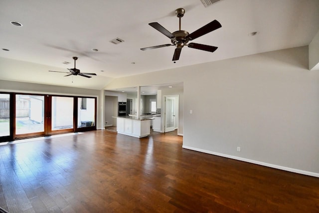 unfurnished living room featuring lofted ceiling, ceiling fan, dark wood-type flooring, visible vents, and baseboards