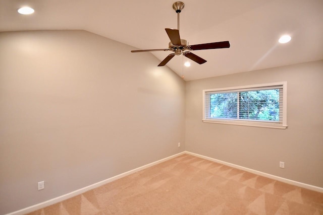 unfurnished room featuring lofted ceiling, light colored carpet, baseboards, and recessed lighting