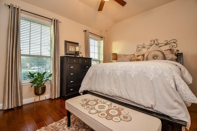 bedroom featuring lofted ceiling, dark wood-style floors, baseboards, and ceiling fan