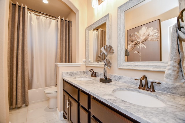 full bathroom with double vanity, toilet, shower / bath combo, and a sink